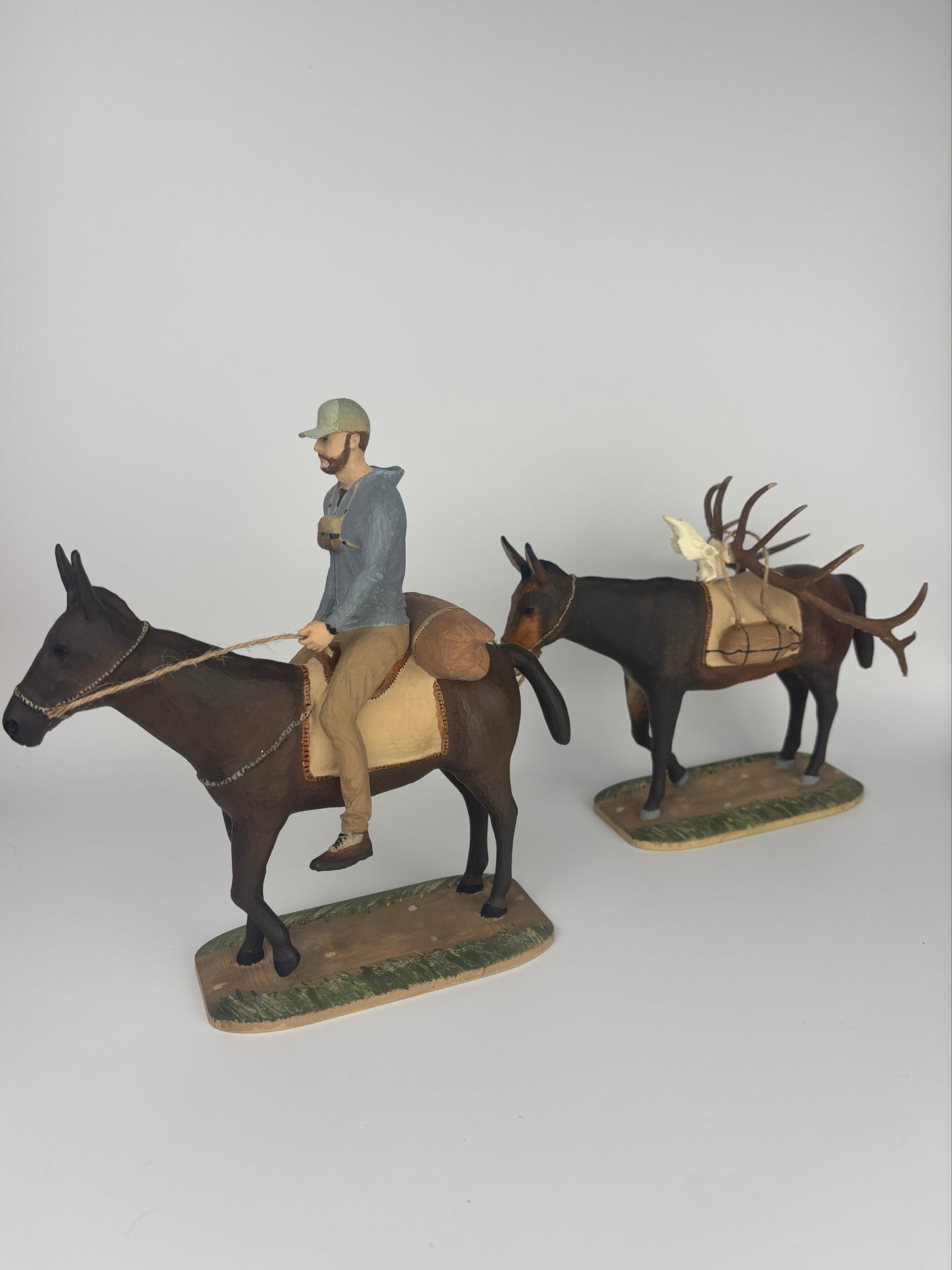 A mini scene of a man riding his mules with a replica euro mount of his bull.