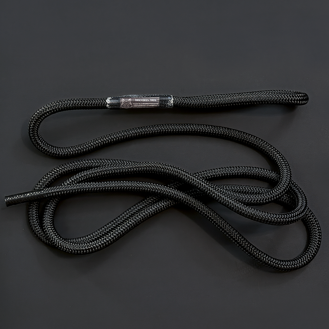 A black braided rope with a metallic silver metal tip, coiled on a dark gray background. Replacement rope / tether  from Raccoon Rigs.