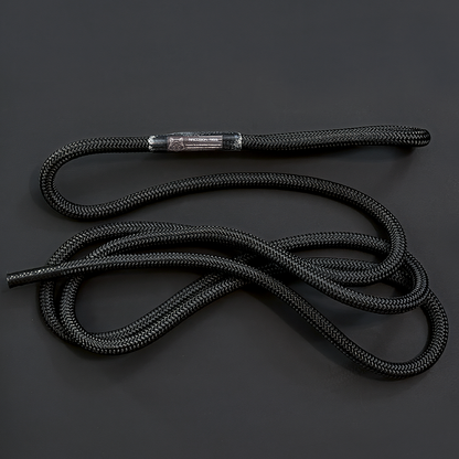 A black braided rope with a metallic silver metal tip, coiled on a dark gray background. Replacement rope / tether  from Raccoon Rigs.
