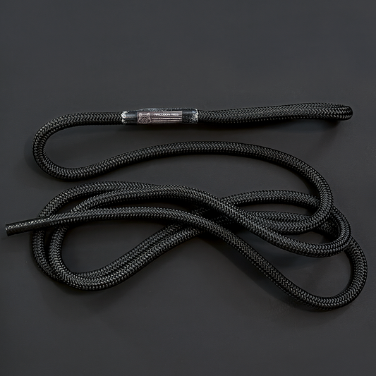 A black braided rope with a metallic silver metal tip, coiled on a dark gray background. Replacement rope / tether  from Raccoon Rigs.